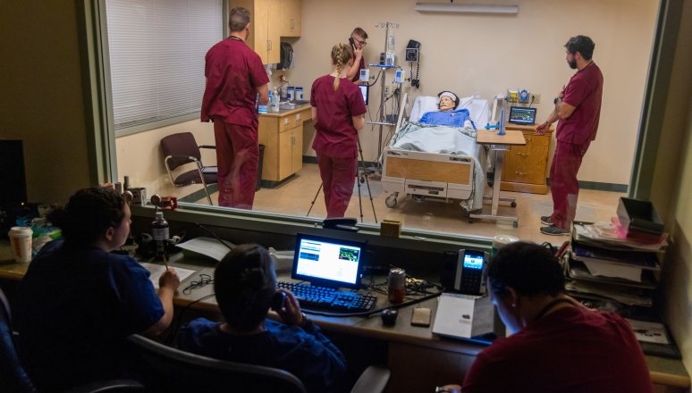 Norwich faculty provide guidance inside the Nursing simulation lab.