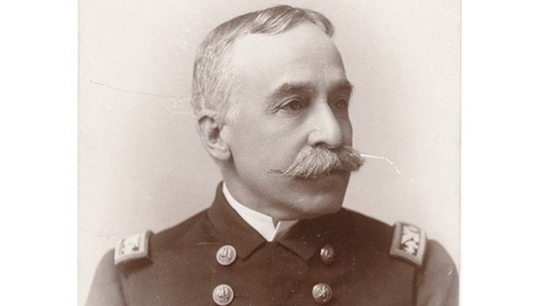 Old sepia photograph of Admiral George Dewey with mustache in uniform