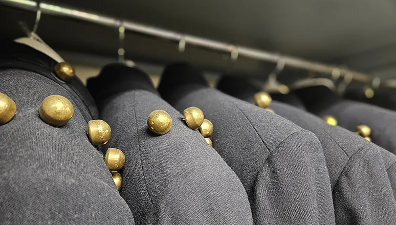 Sullivan Museem Collection Uniforms hanging in storage