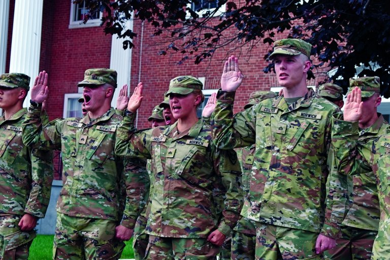Norwich University Corp of Cadets with their hands raised