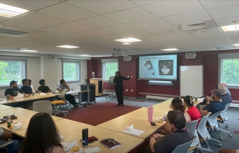 Samriddhi Manandhar presents her work on a projector to the audience.