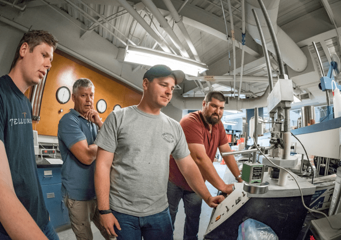 Norwich University Students working a CnC machine