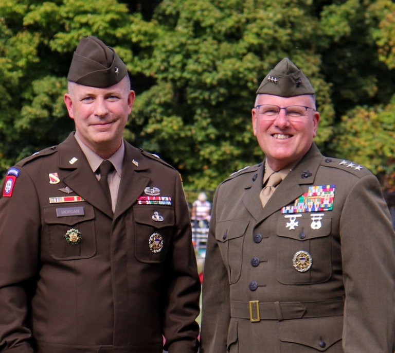 United States Army Brigadier General Shane P. Morgan ’94 and LtGen John Broadmeadow ’83, USMC (Ret), 25th President of Norwich University, in uniform, decorated with medals, smiling outdoors.