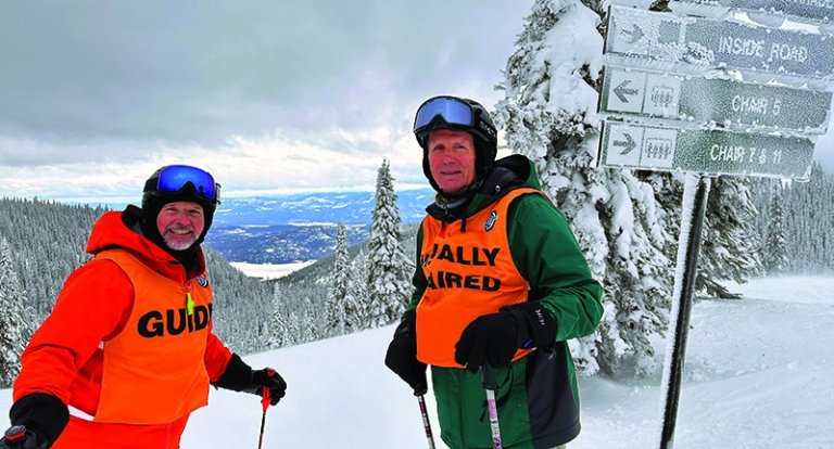 Lt Col Brian O’Connell ’76 pictured on top of ski mountain with Adaptive ski guide