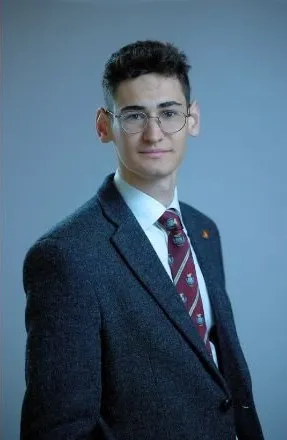 Richard Conlon's formal portrait shot in a suit and tie.