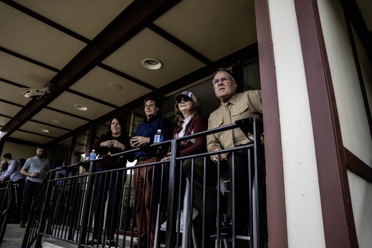 President Broadmeadow and First Lady Broadmeadow enjoy a game from the President's Box among supporters.