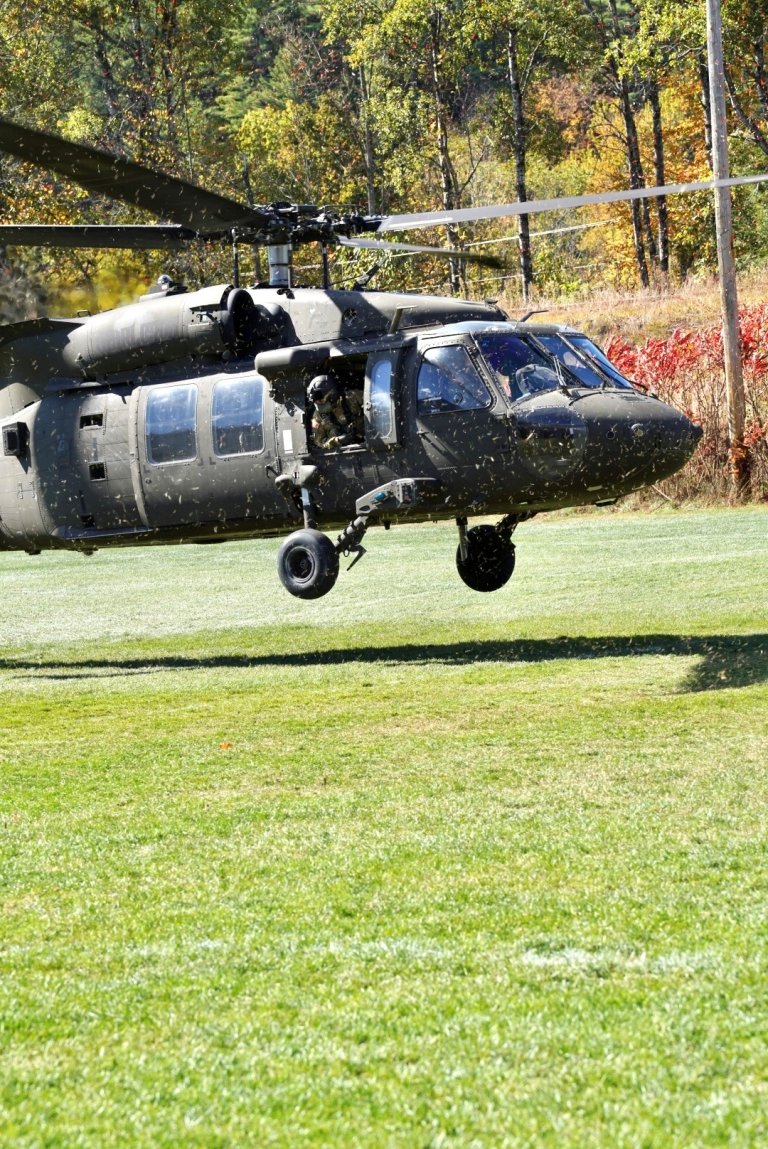 A Black Hawk lands on the field behind Shapiro Field House.