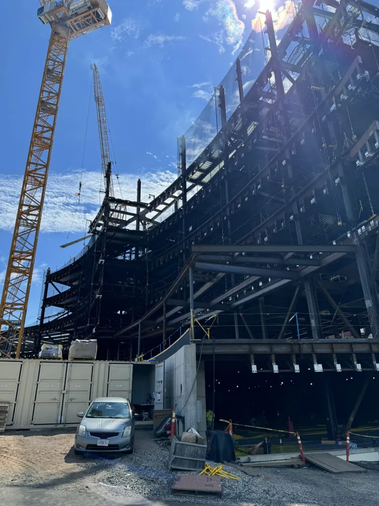 A crane towers over a building being built on a construction site.