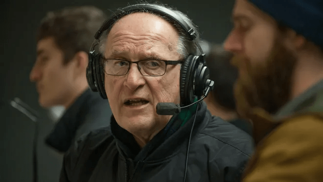 A man calls the game with a headset.