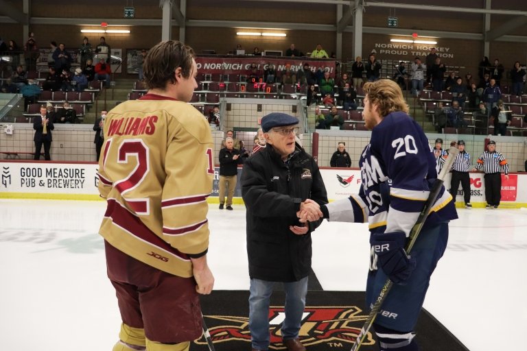 A man shakes hands at center ice prior to puck drop.