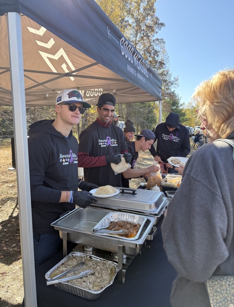 Norwich students serve food during the “Memories Matter” 5K