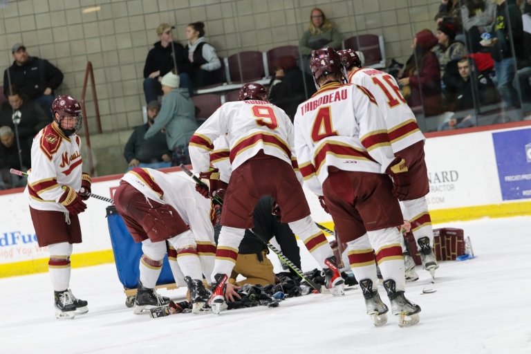 The Cadet players gather socks off the ice.