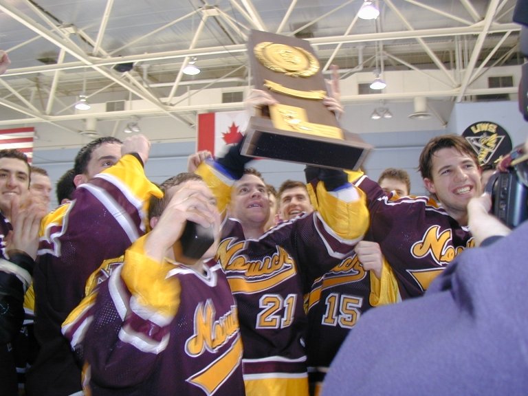 The 1999-2000 team celebrates with the trophy.