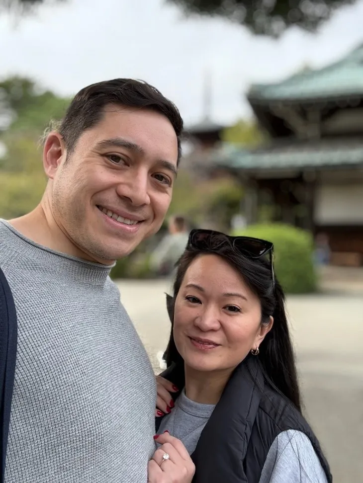 A man and woman smile in a selfie.