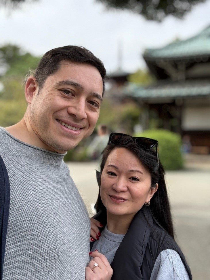 A man and woman smile in a selfie.