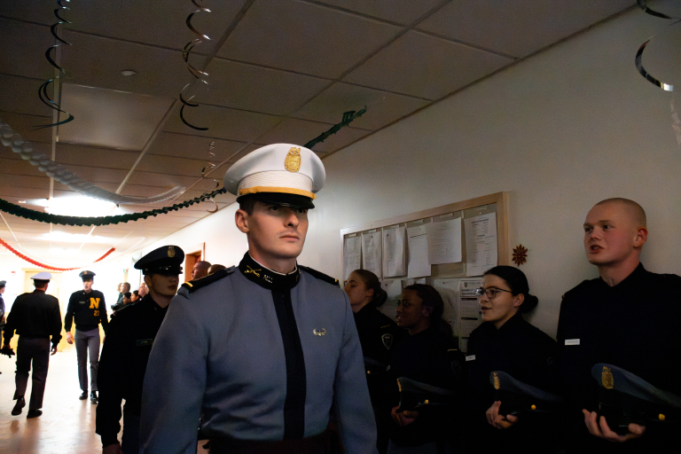 Cadets and cadre prepare the Rooks along a dormitory hallway.