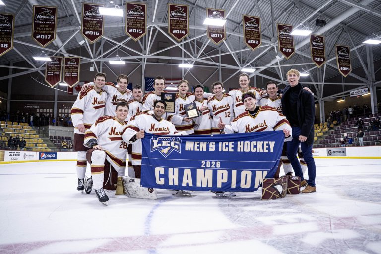 Norwich hockey players pose on the ice with a 2026 LEC men's ice hockey champion banner and two plaques.