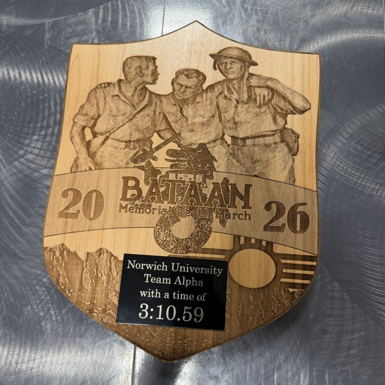 Wooden plaque for the Bataan Memorial Death March 2026 honors Norwich University Team Alpha's 3:10.59 time.