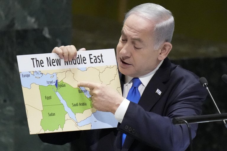 Person holding a map of the Middle East pointing to Bahrain.