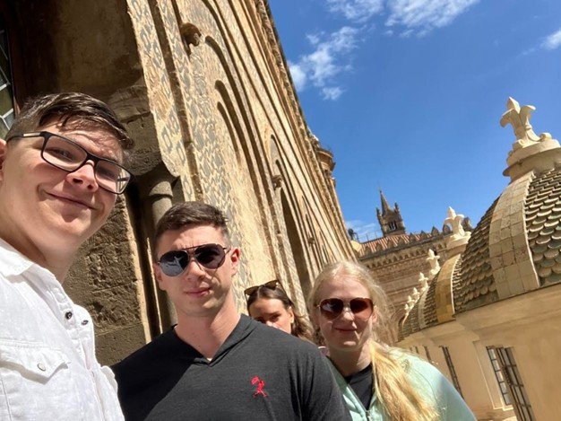 A group of people take a selfie while in Palermo, Italy.