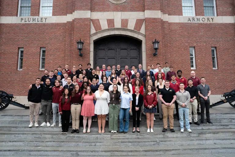 Large group of students pose on the steps outside Plumley Armory.