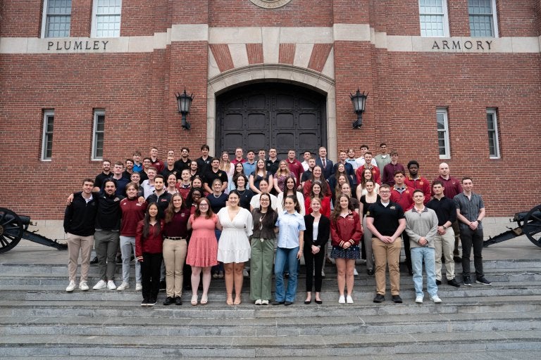 Large group of students pose on the steps outside Plumley Armory.