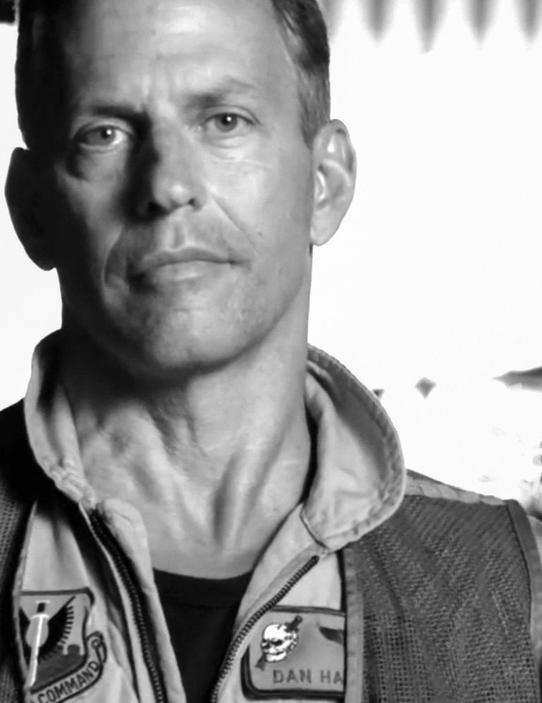 Black and white photo of a man in a military flight suit