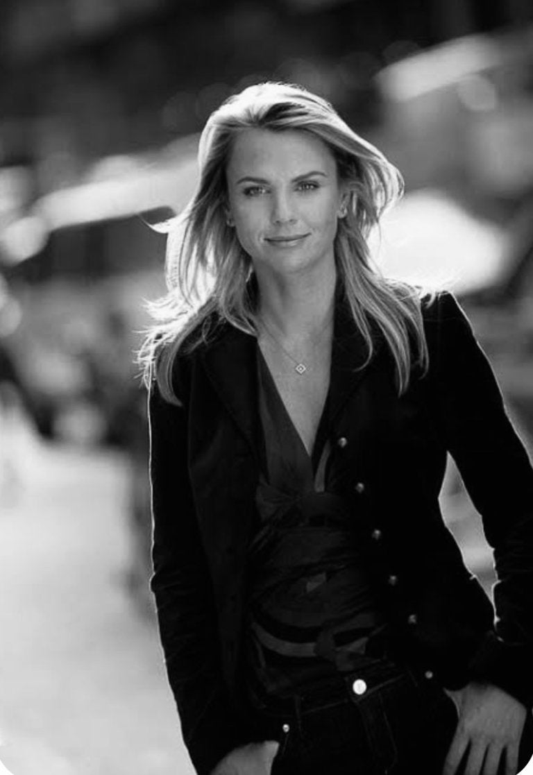 Black and white photo of a women in a black button down shirt