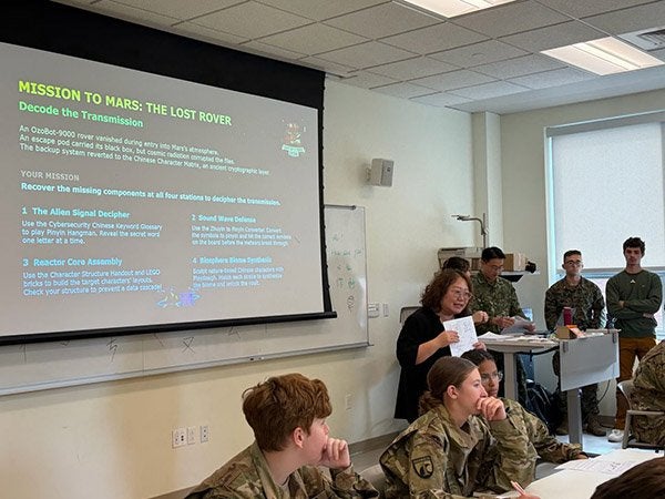 Cadets and other participants gather in a classroom during a Mission to Mars cybersecurity presentation.