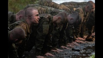 A line of recruits pause during the annual Dog River Run to enjoy some push-ups as they embrace an event that has become a right of passage for new cadets after their first week of basic training.
