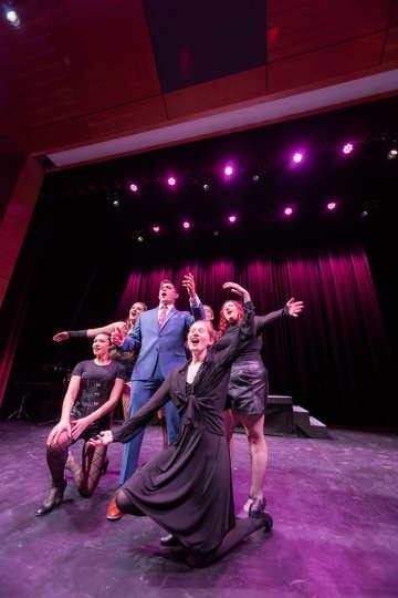 The Pegasus Players- Chicago - cast on stage singing