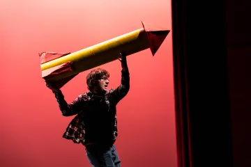 Pegasus Players - She Kills Monsters - Actor on stage holding missile