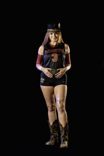 Rae Lawing poses in uniform against black background with large belt buckle and hat with feather.