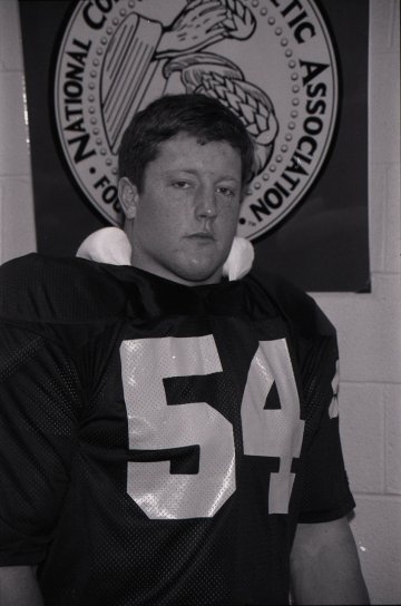 football player in uniform and pads, wearing #54, Mike Norman '86