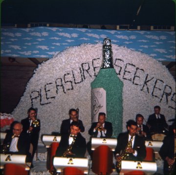 	 Color slide of decorations for the theme of Ring Weekend (Junior Week) for Class of 1966, photographed in May 1965, with band performing in foreground.