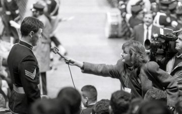 Norwich cadet Mark Young '86 talking to news reporter from Boston channel 5 at 1985 presidential inauguration