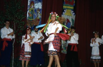 woman in slavic dress on stage in a performance