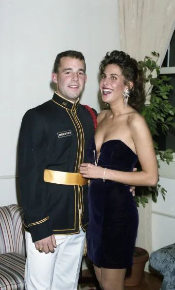 cadet in uniform stands next to his date in dress