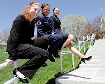three women sitting on a stair railing. [l to r] Amber Heckmann '11, Unna Lee and Victoria Amador '11