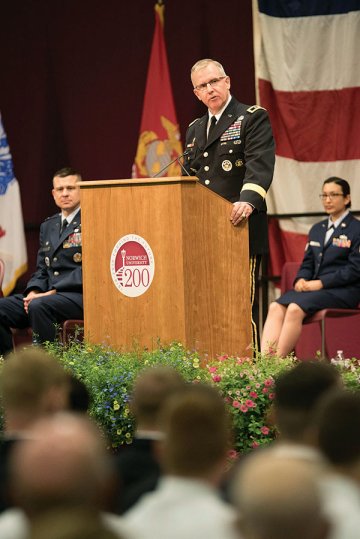 Man in military uniform at a lectern addressing a crowd. Photo of Army Maj. Gen. John Baker '85 at Norwich University's Commissioning Ceremony, 2016.