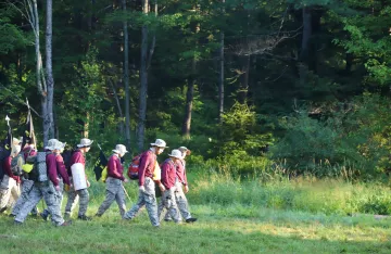 FLC campers walking through the woods.