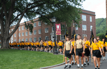 FLC campers marching across campus in yellow t-shirts.