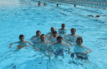 FLC campers smiling up from the swimming pool.