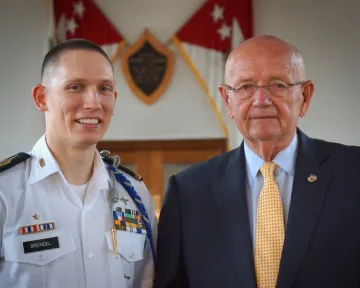 A young man smiles in white formal military shirt next to an older man in suit and tie. Photo of Alex Breindel (NU'15), of Goldsboro, N.C., selected to serve as the 2015-16 Regimental Commander, the highest-ranking cadet of Norwich University’s Corps of Cadets (NUCC). GEN Gordon R. Sullivan (dec.), USA (Ret.) NU'59 is at right.
