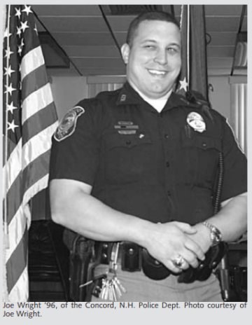 Man smiling in a short-sleeve policeman's shirt. Caption to photo: Joe Wright '96 of the Concord N.H. Police Dept. 