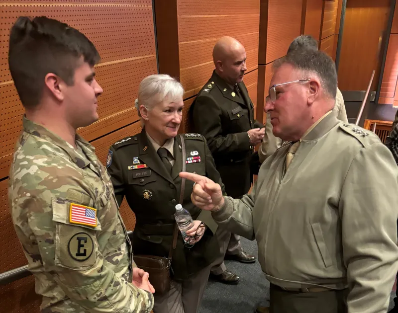 LtGen Broadmeadow and LTG Potter share a moment and speak with a Norwich student.