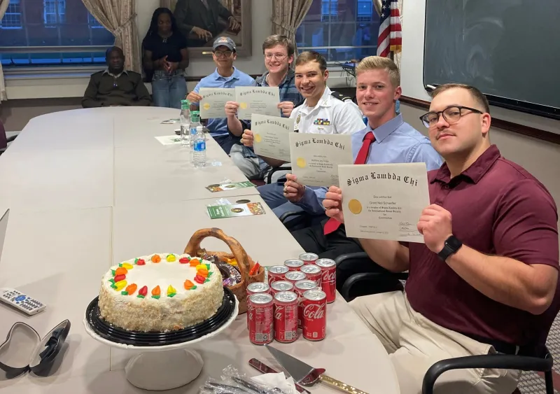 Five students holding their certificates of Induction to the School of Engineering Sigma Lambda Chi