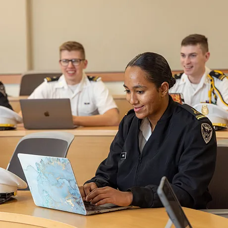 Norwich Student in class typing on laptop