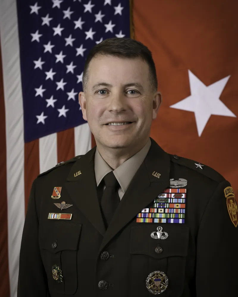 Professional photo of United States Army Brigadier General Shane P. Morgan in uniform standing in front of a United States flag.