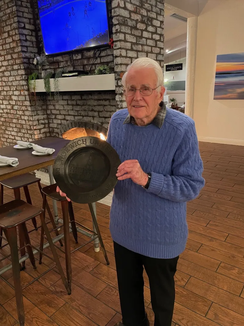 Dave Luce '54 holds his brother's melted award which he salvaged from the Palisades Fires.